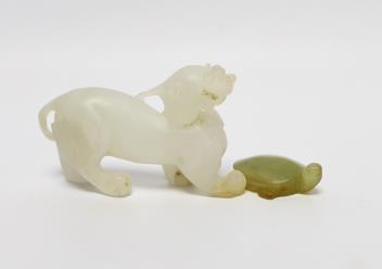 A 19th century Chinese jade model of a lion-dog, 9cm, together with a hardstone ‘tortoise’ pendant